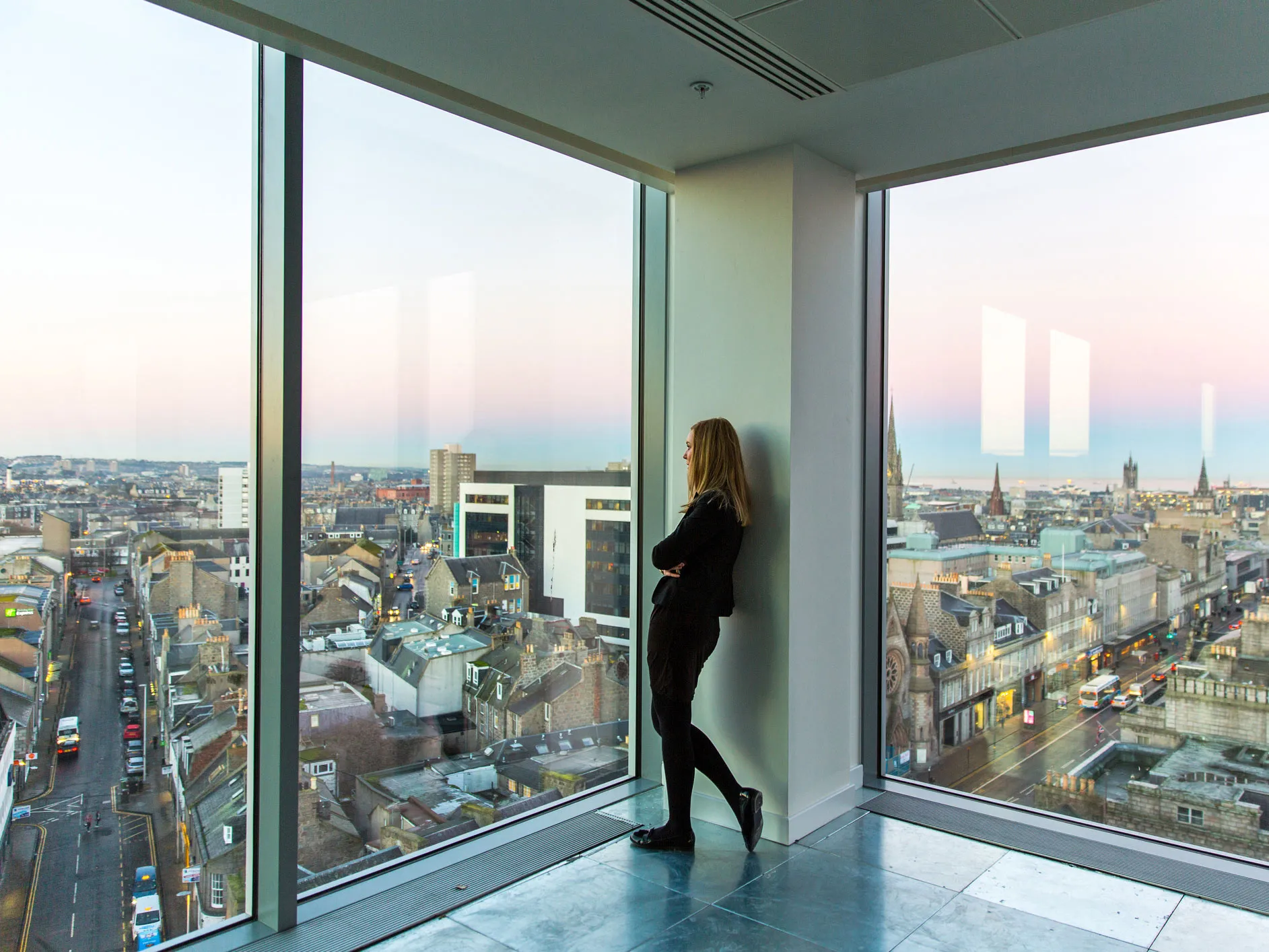 woman looking out over aberdeen skyline
