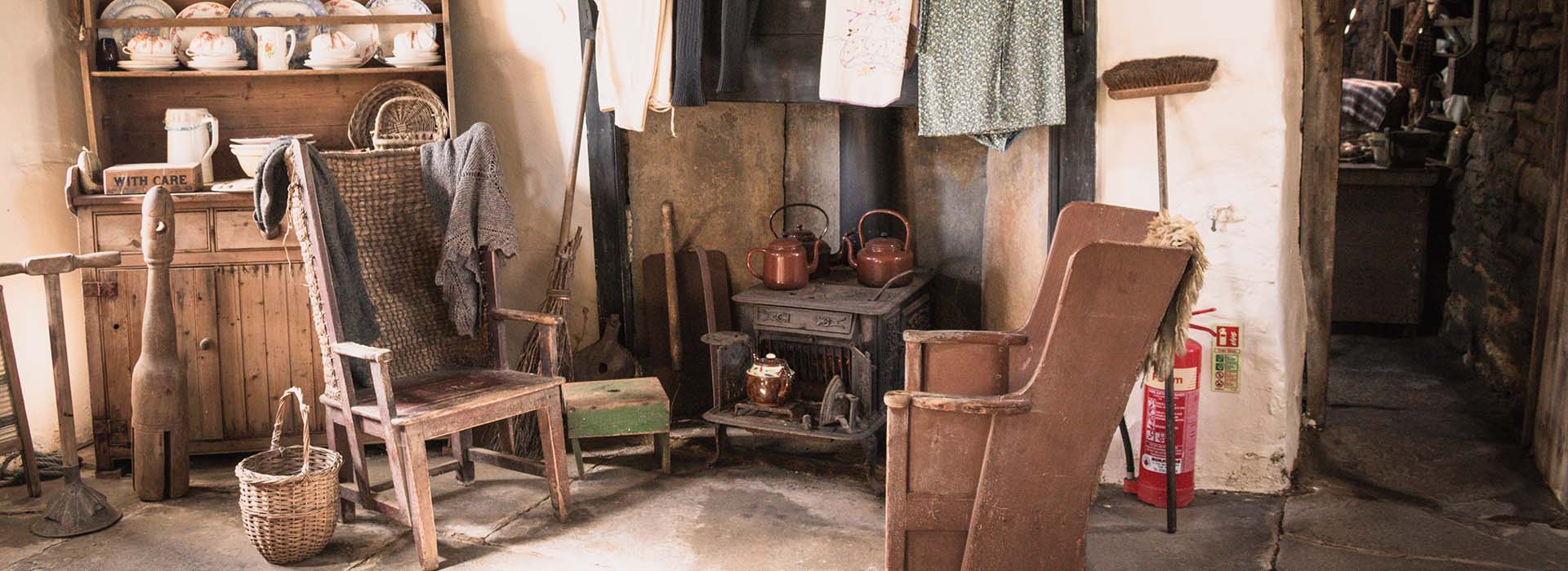 Old fashioned chairs sat around a fireplace