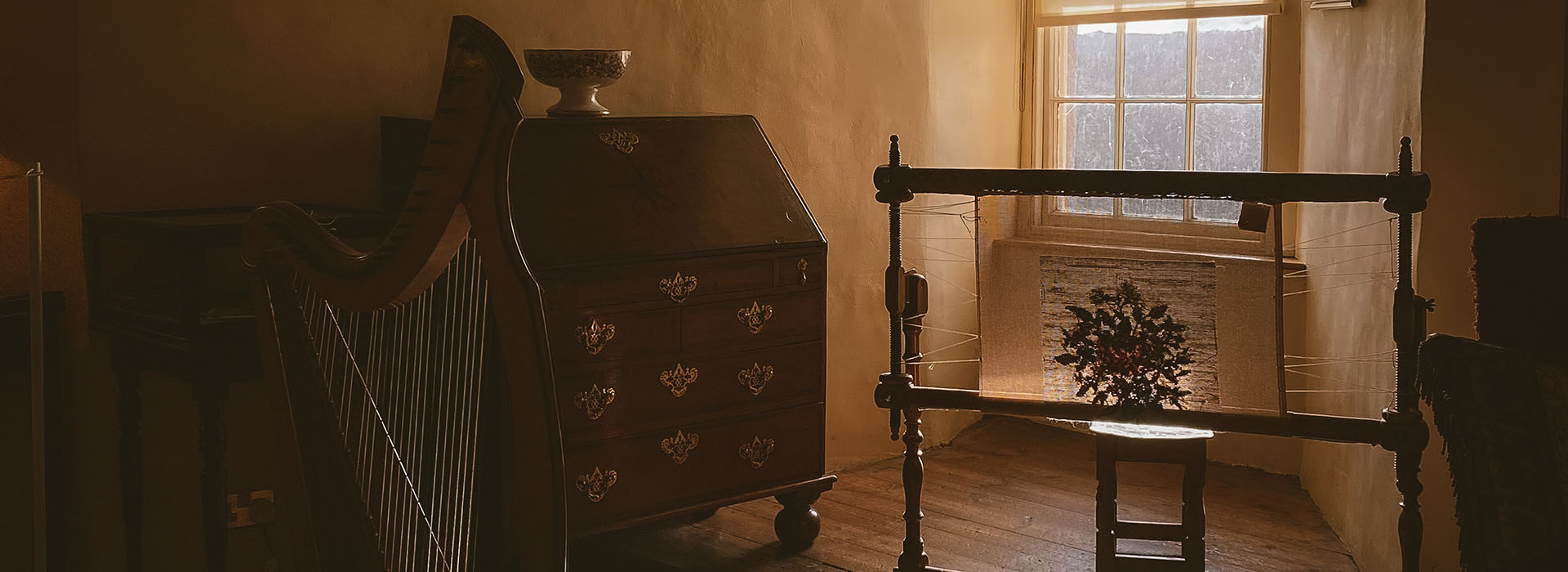 room with dresser, harp and various furnishings