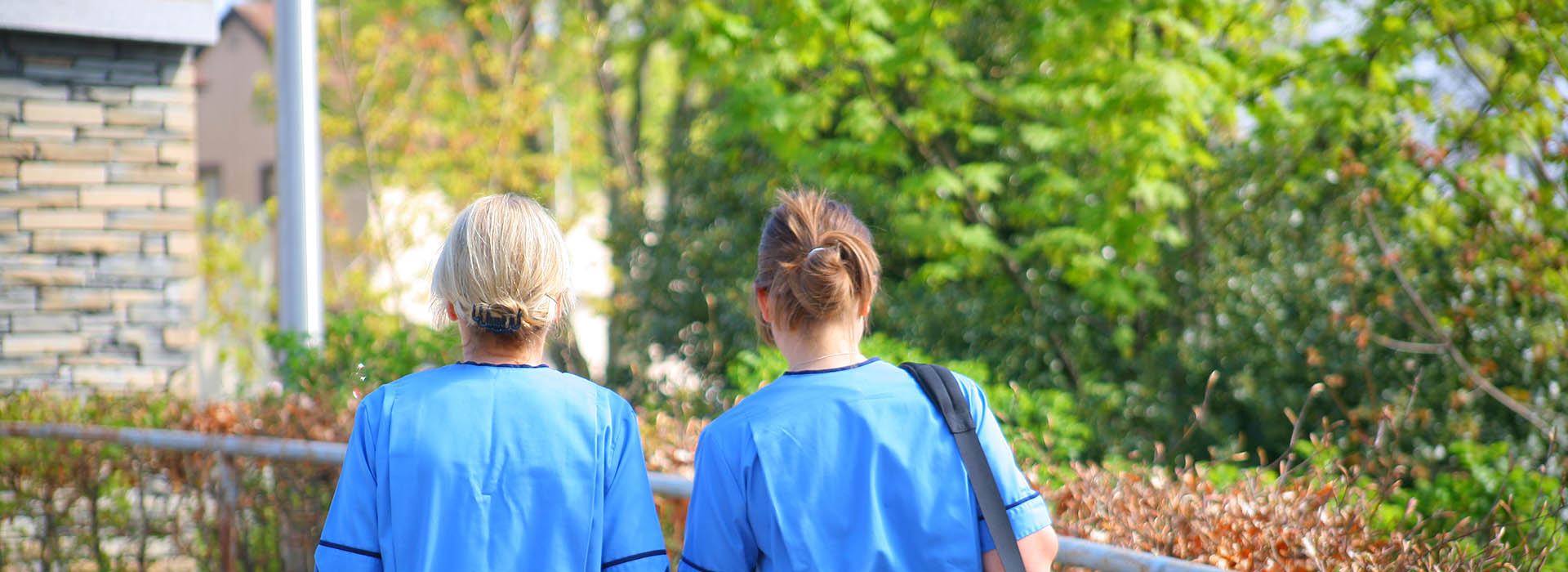 two health professionals walking outdoors
