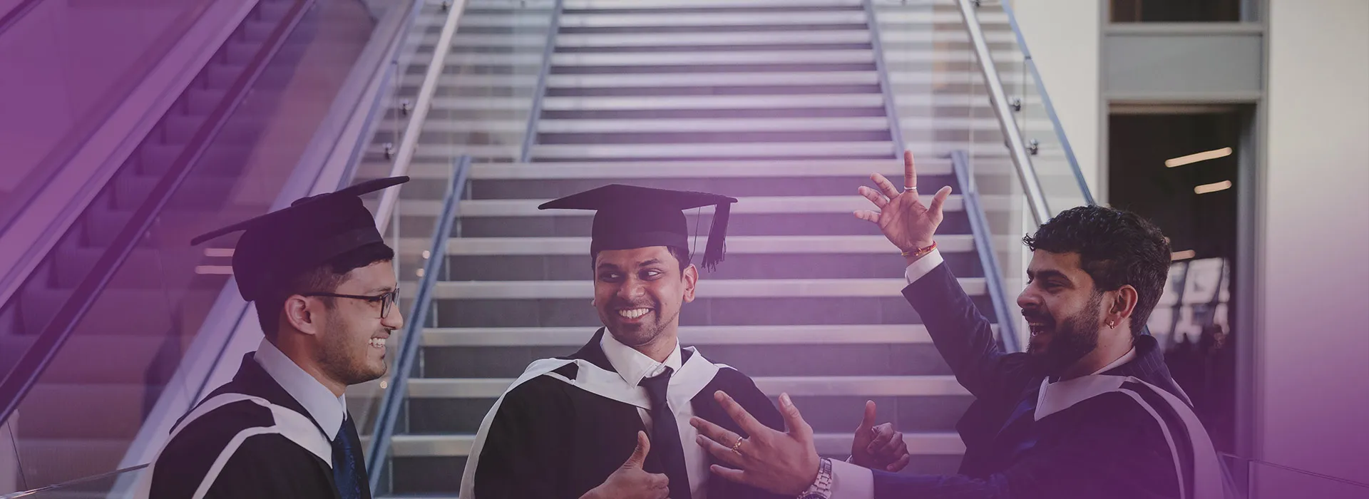 3 students celebrating at graduation