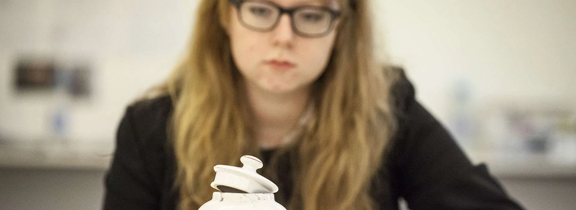 student looking at ceramic sculpture