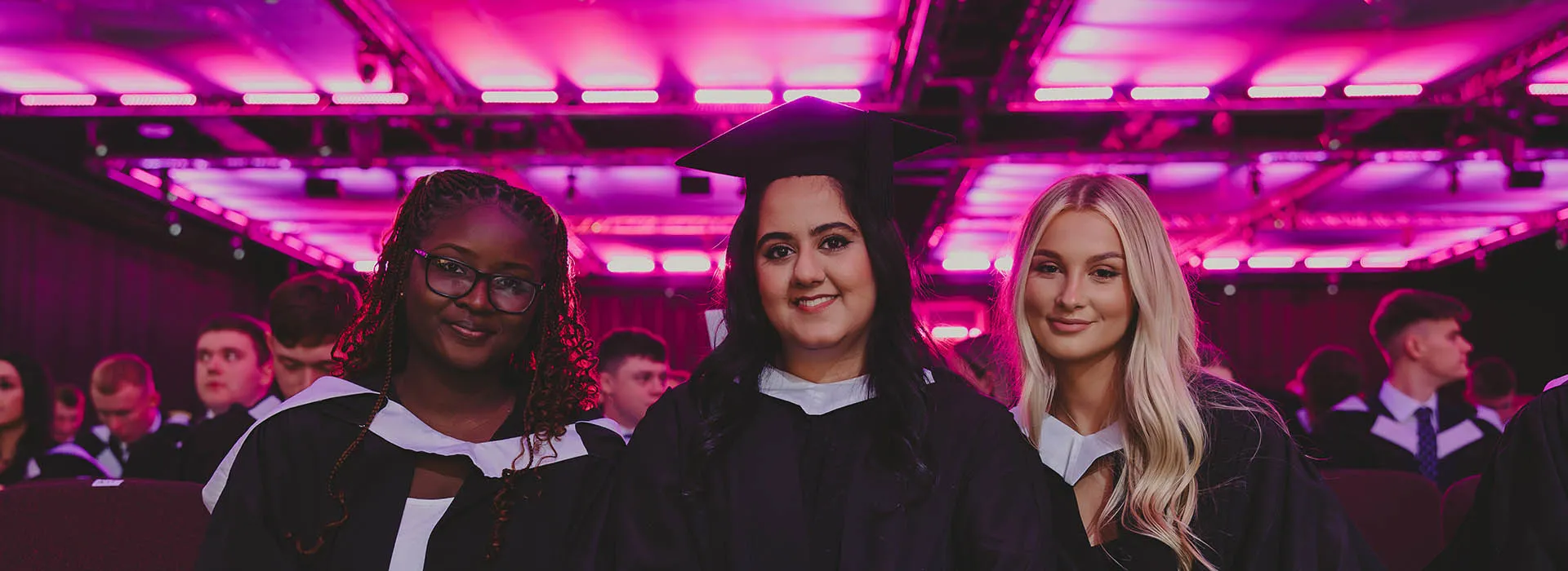 three graduates wait for their ceremony