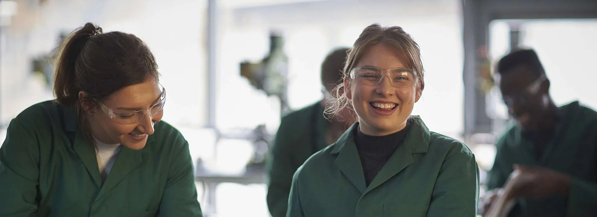 students in green work coats