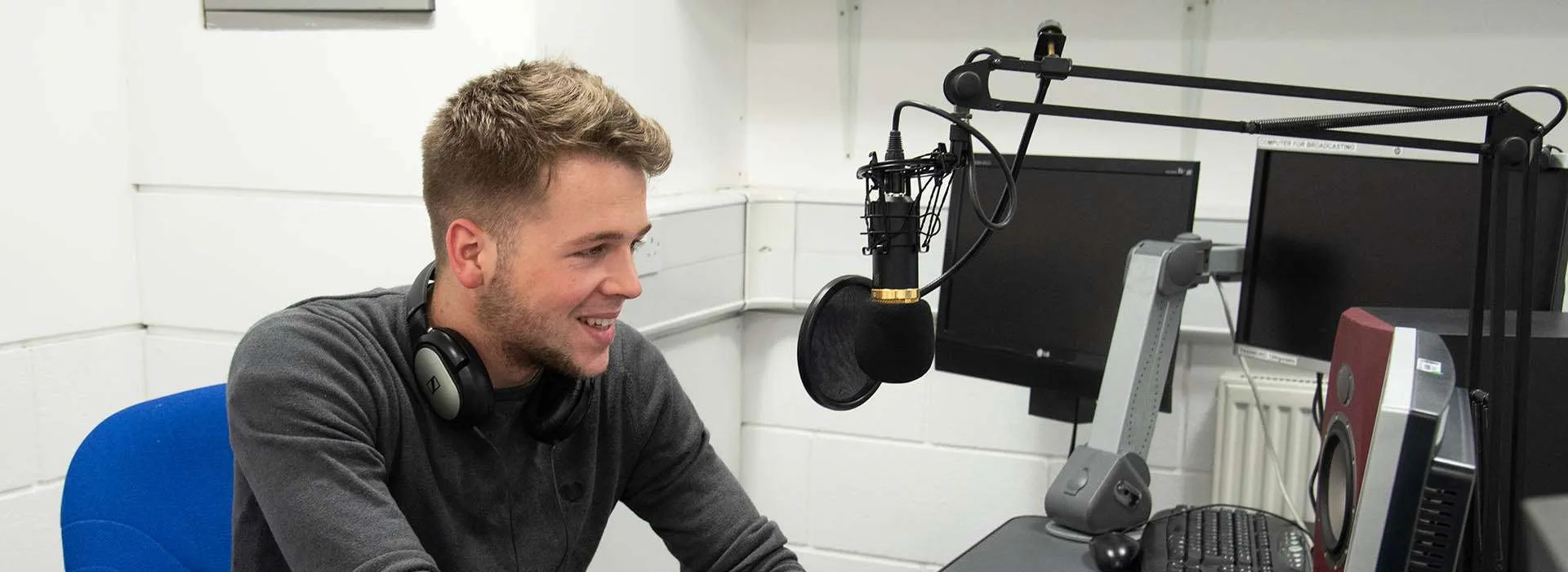 student talking into mic in Radio Studio