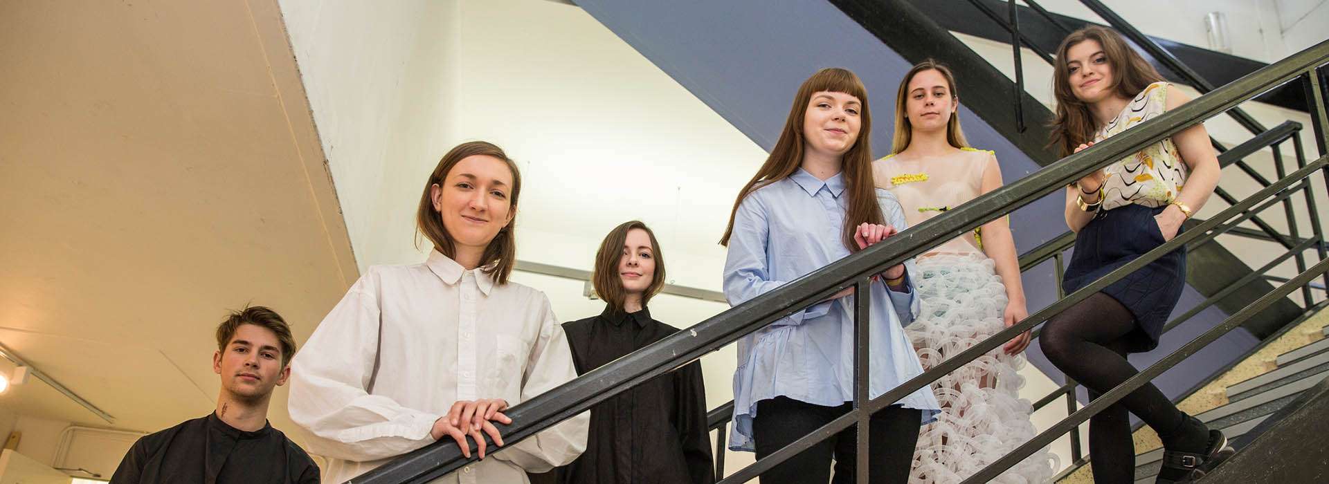 students standing on stairs looking down