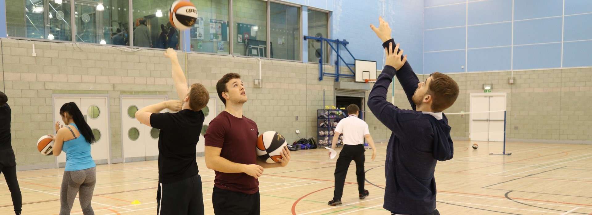 students practicing basketball together