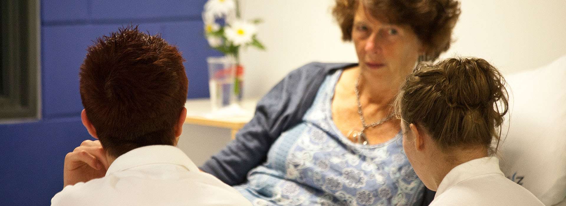 two health professionals attending to a patient