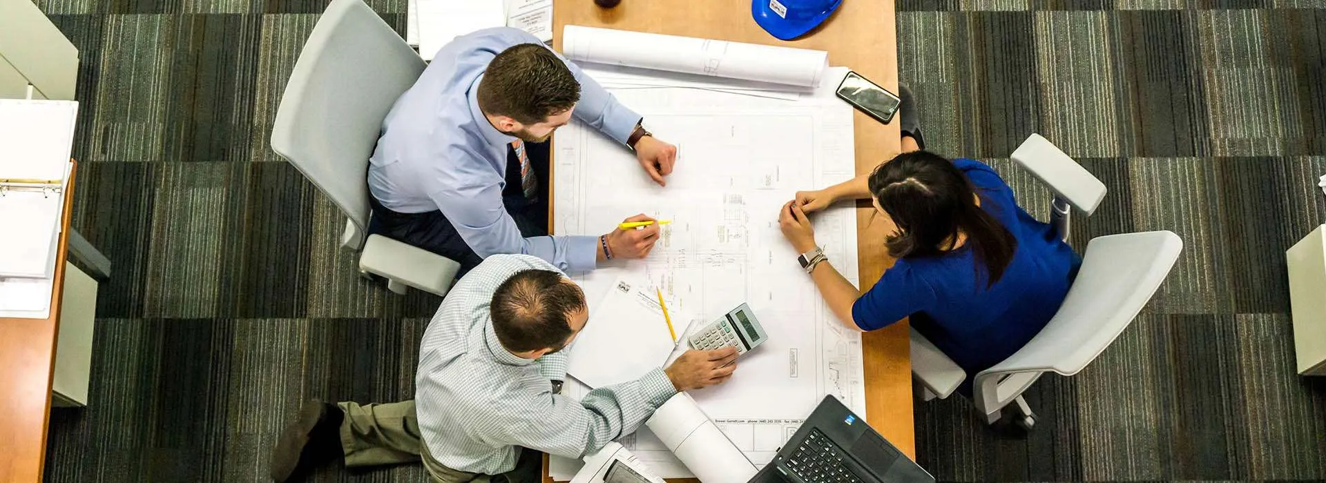 top view of people in a meeting over a desk