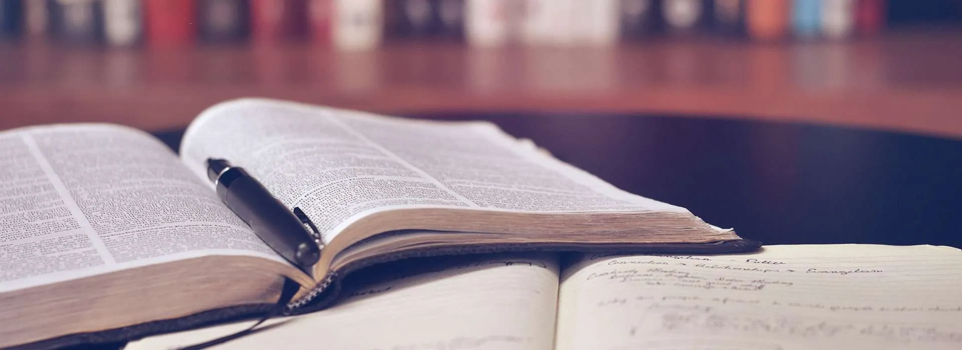 open book with pen on top