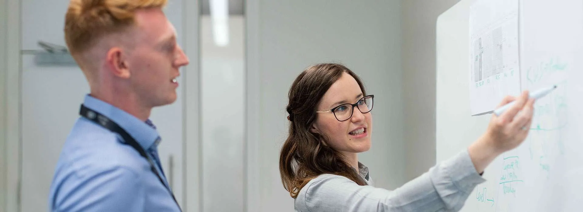 people writing on whiteboard