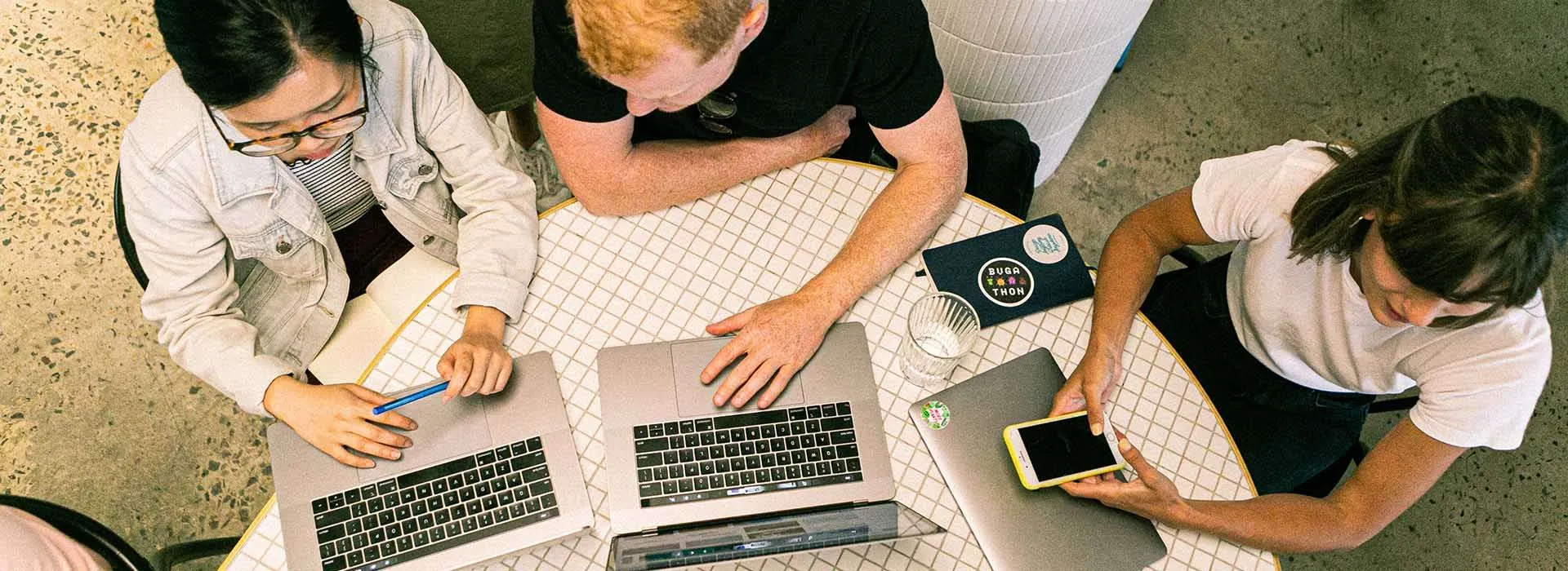 people using laptops on a desk