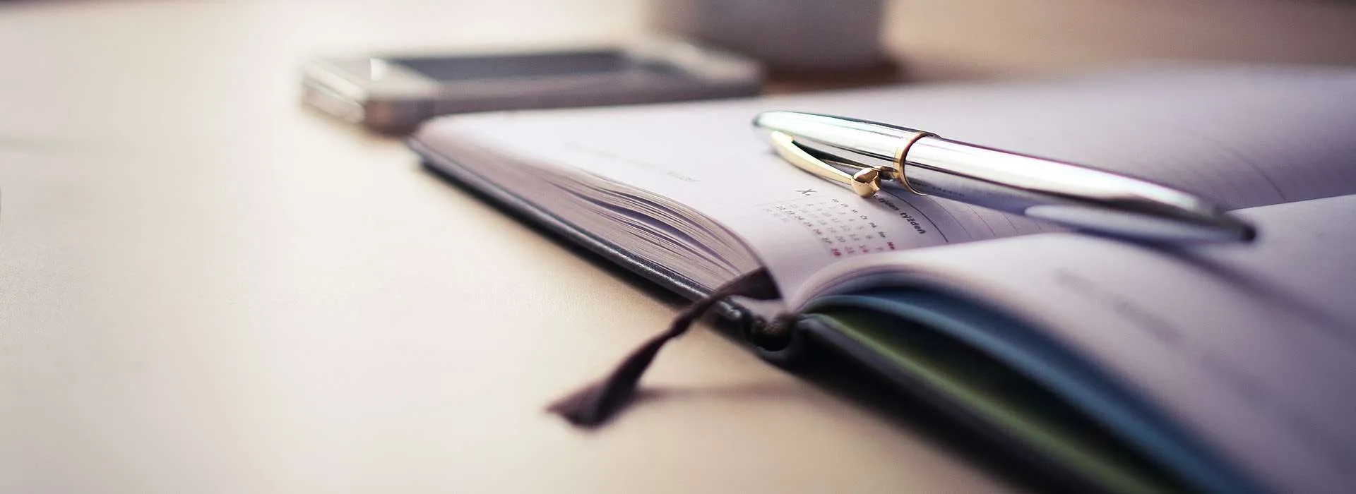 pen resting on calendar notebook