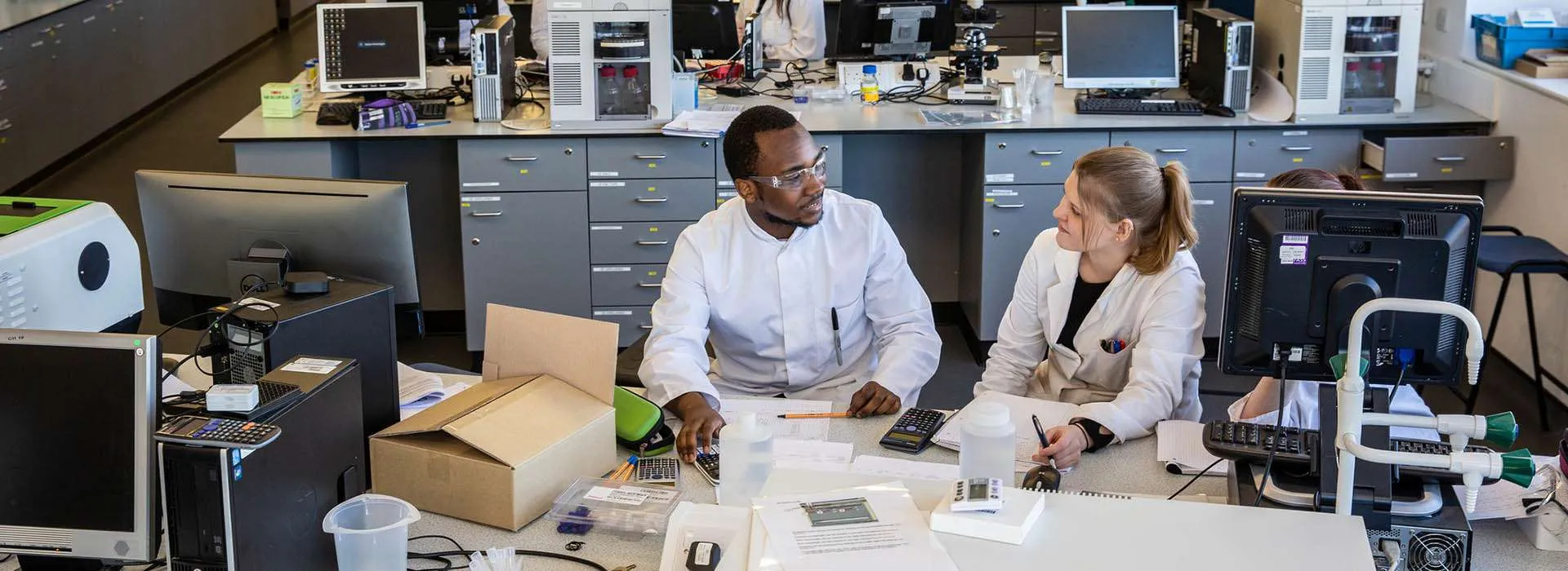 students chatting in life sciences lab