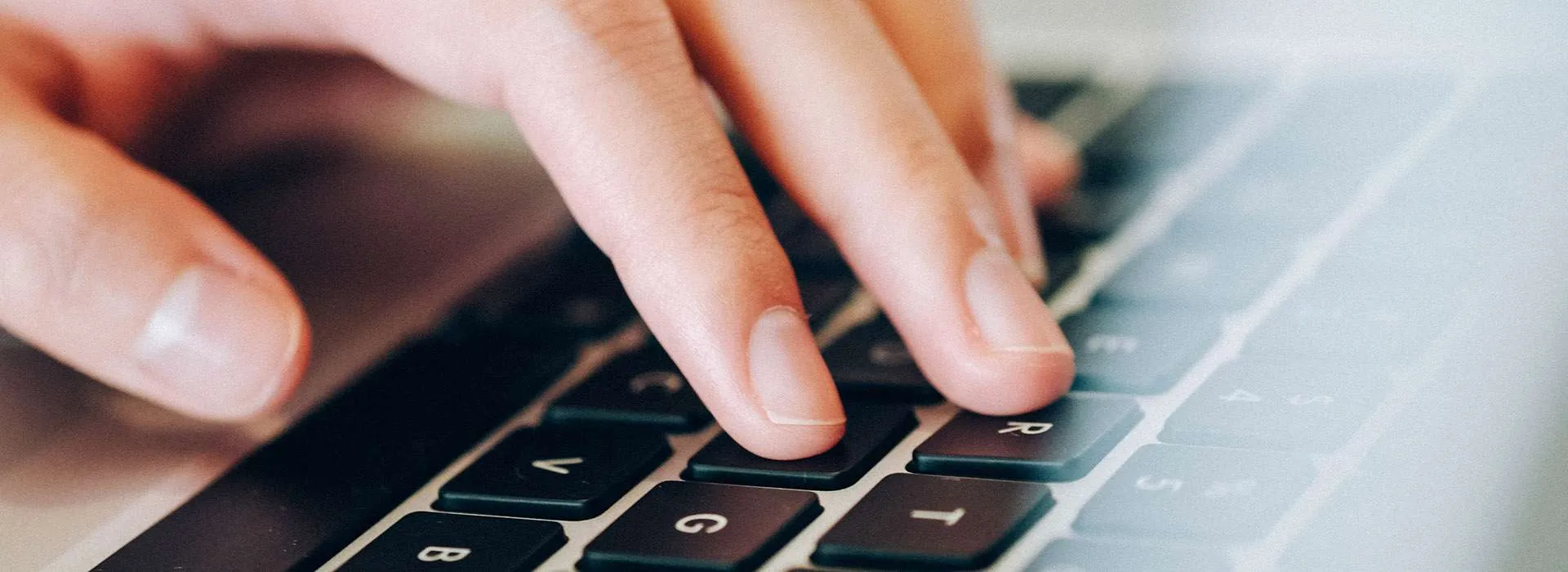 fingers typing on a keyboard