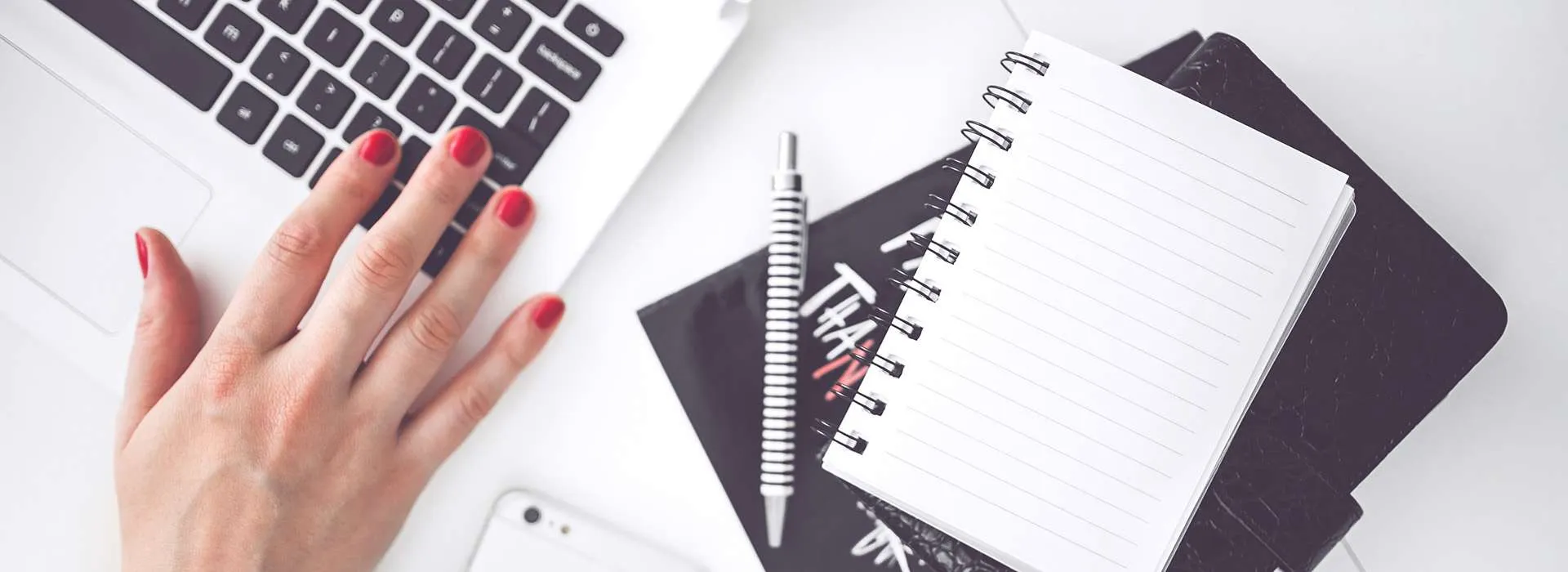 desk with laptop, notebook and mobile phone