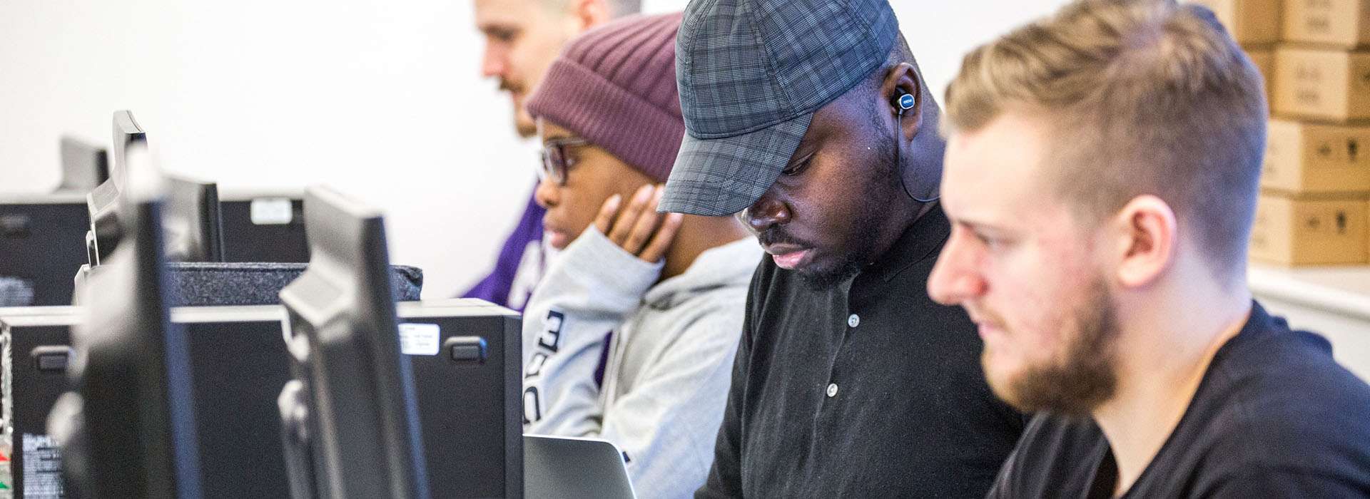 students looking at computers in lab