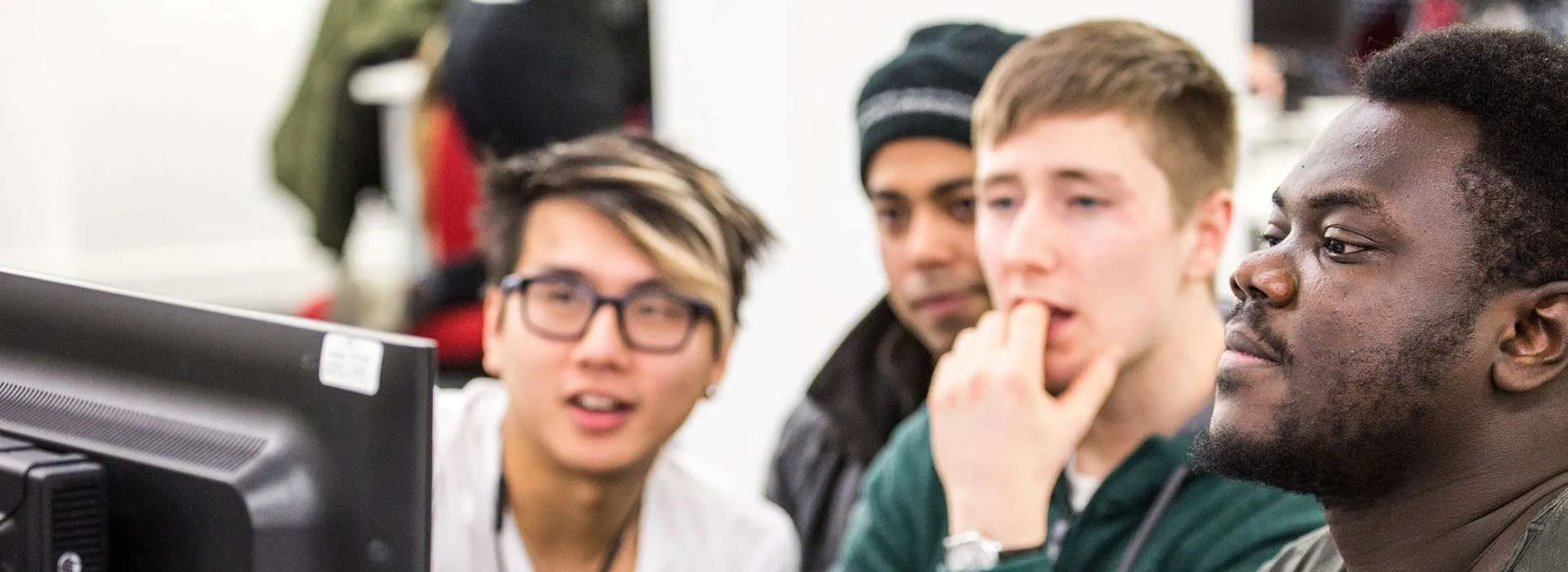 students crowded around a computer