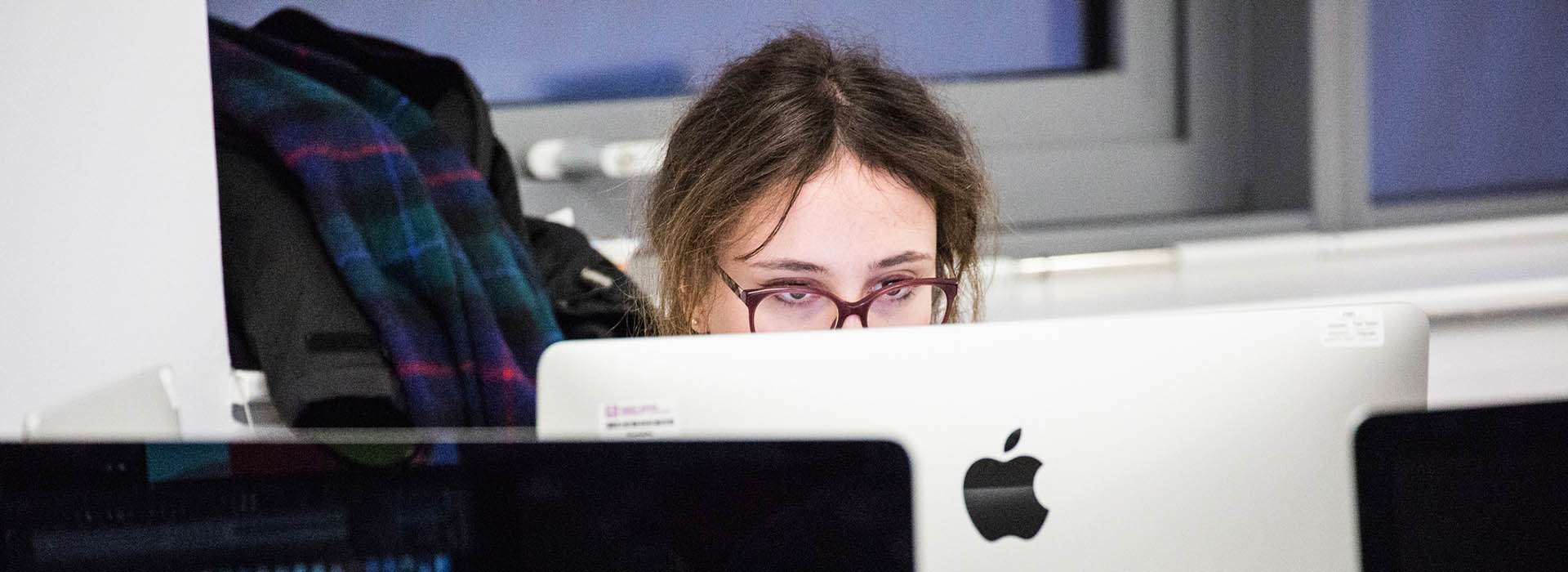 student working on mac in digital suite