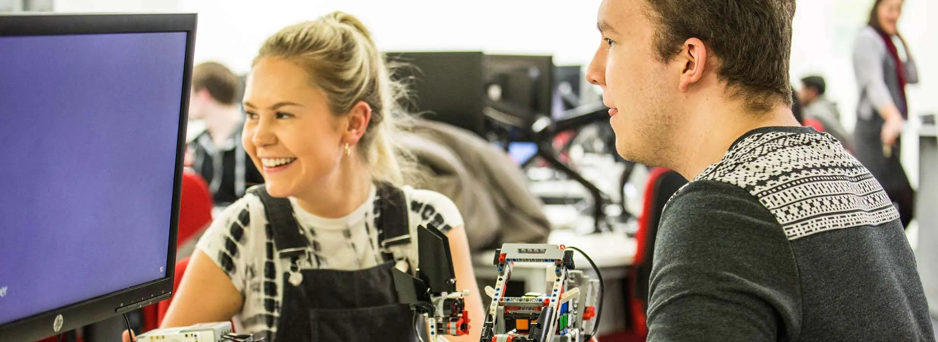 Two people sat at computer