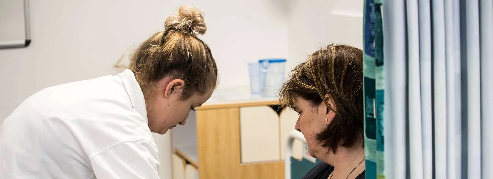 student nurse taking someone's pulse