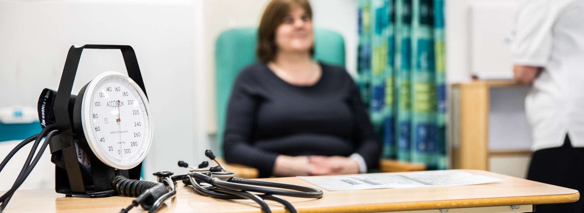 patient sitting next to medical equipment