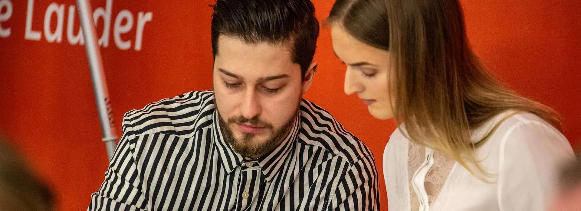 two people looking over a notebook in the innovation station