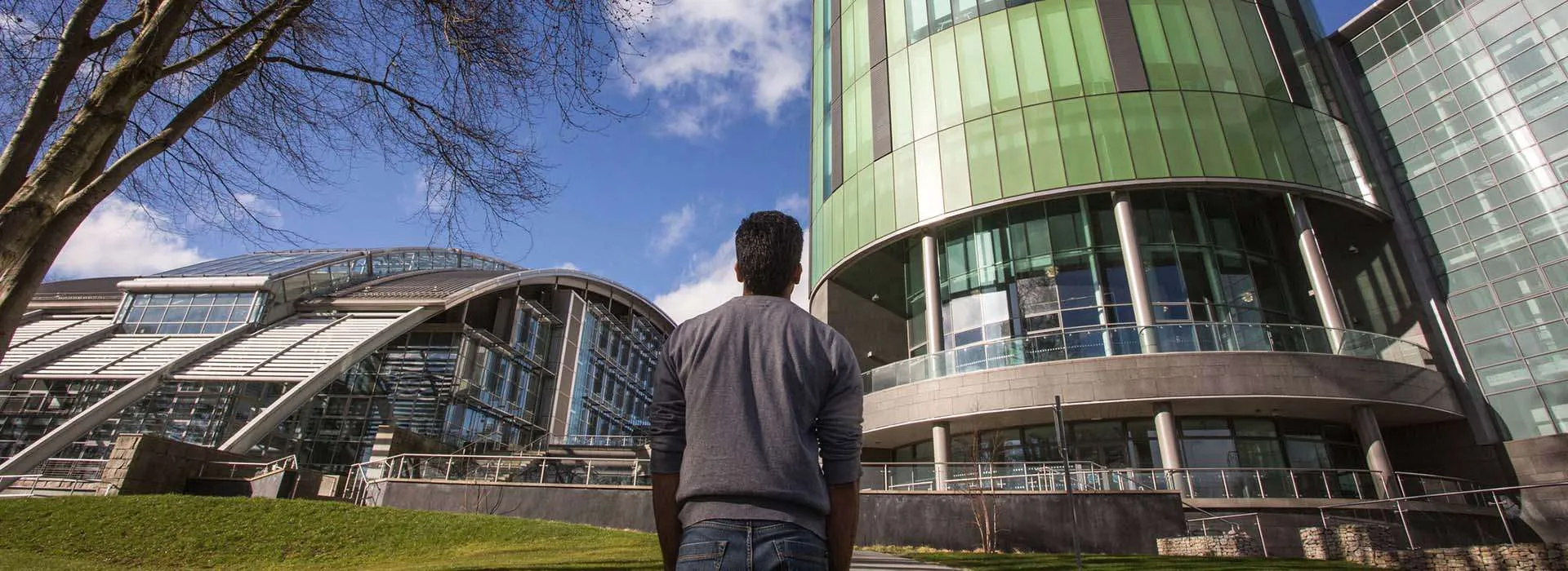 student looking up at RGU Library