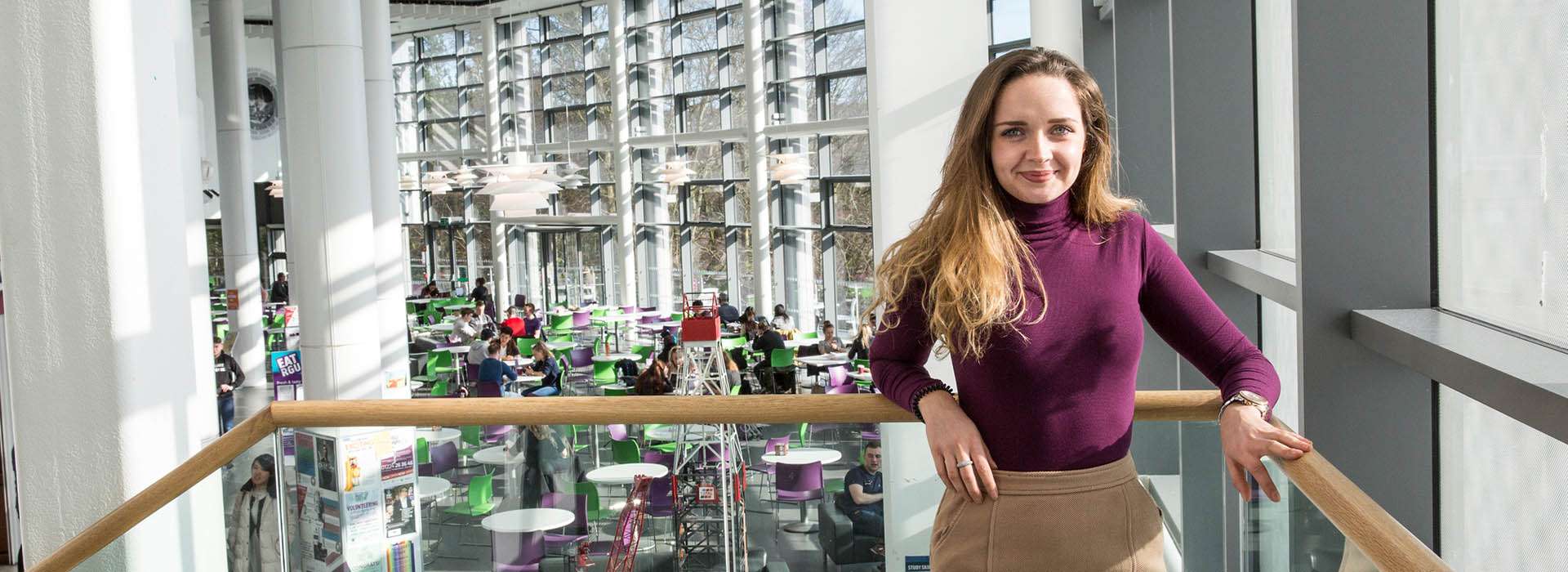 student standing on stairs in sir ian wood building