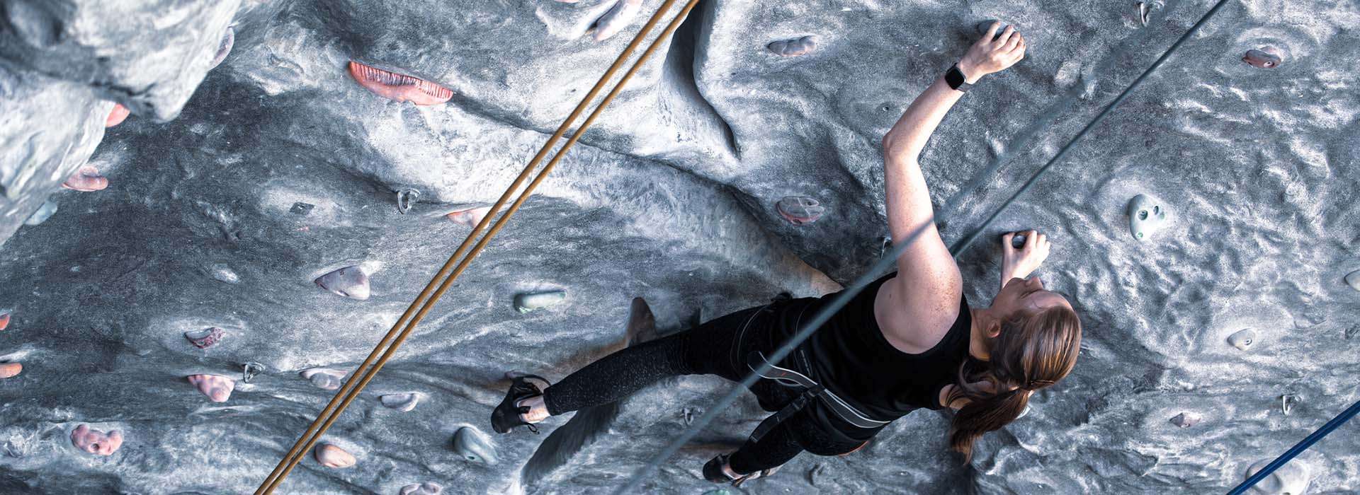 A person using the climbing wall at RGU Sport