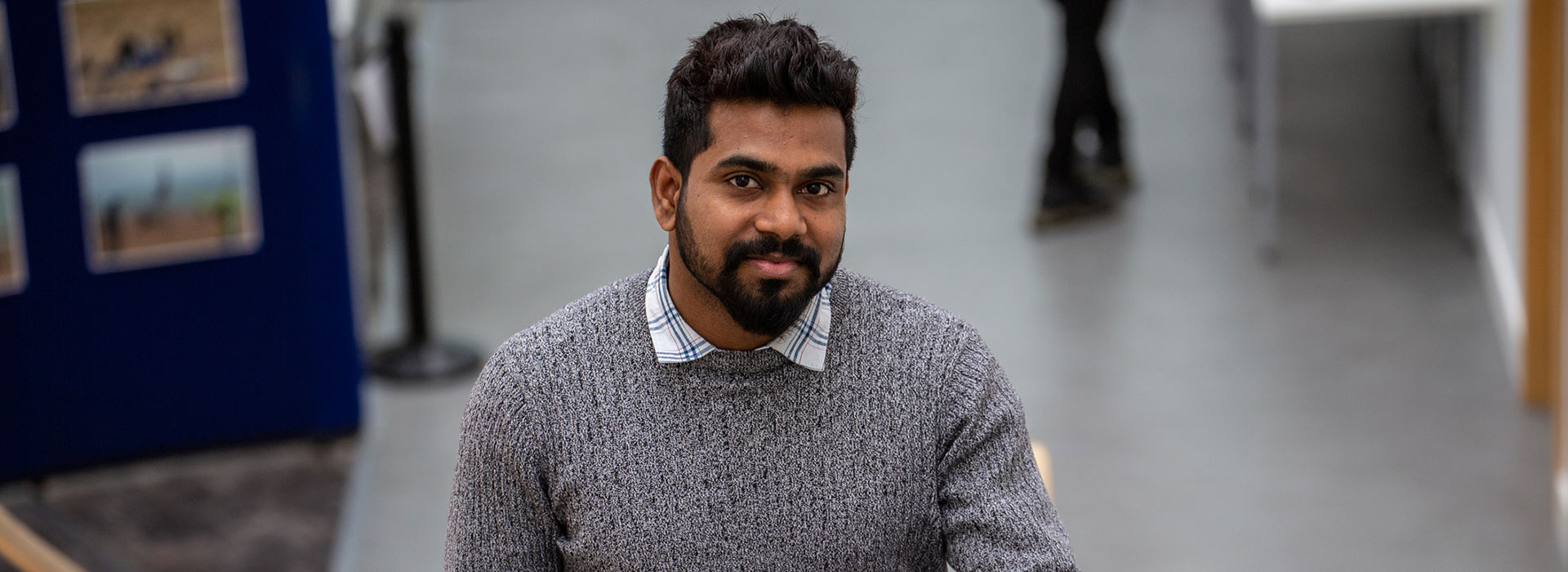 student walking up the stairs on campus