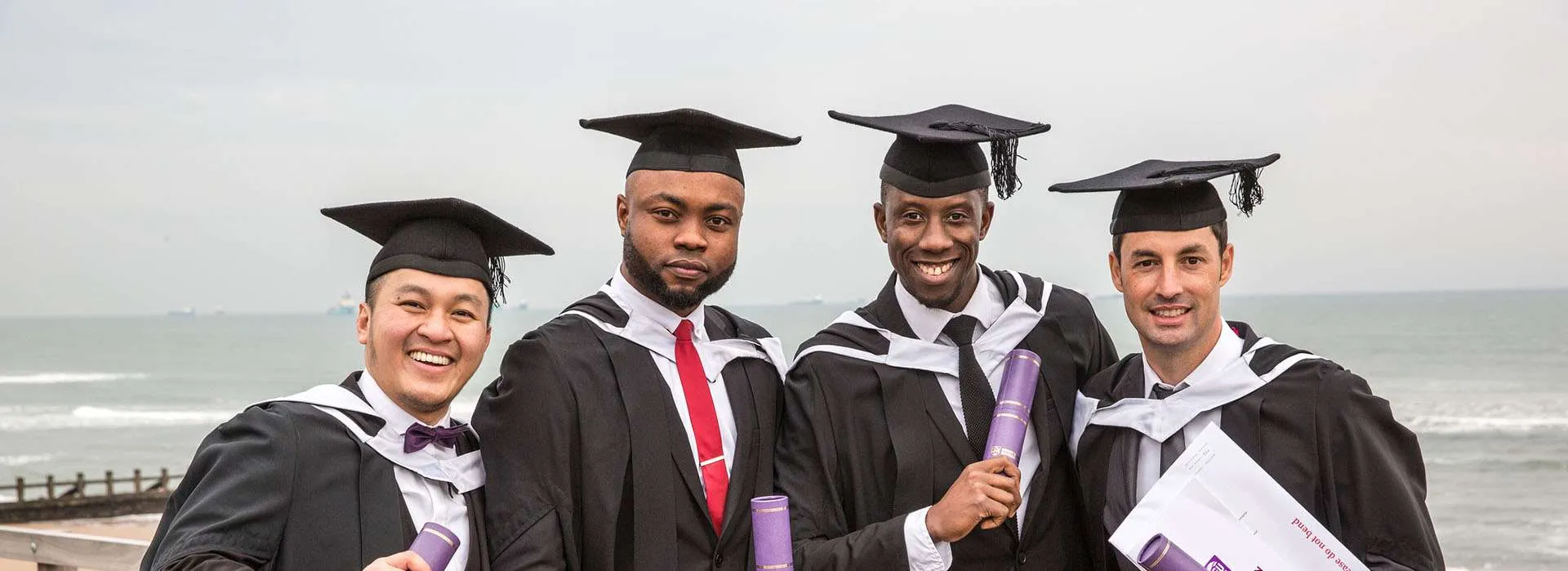 graduates smiling at aberdeen beach
