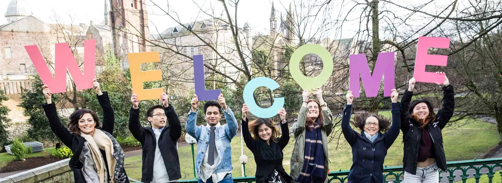students holding the letters for