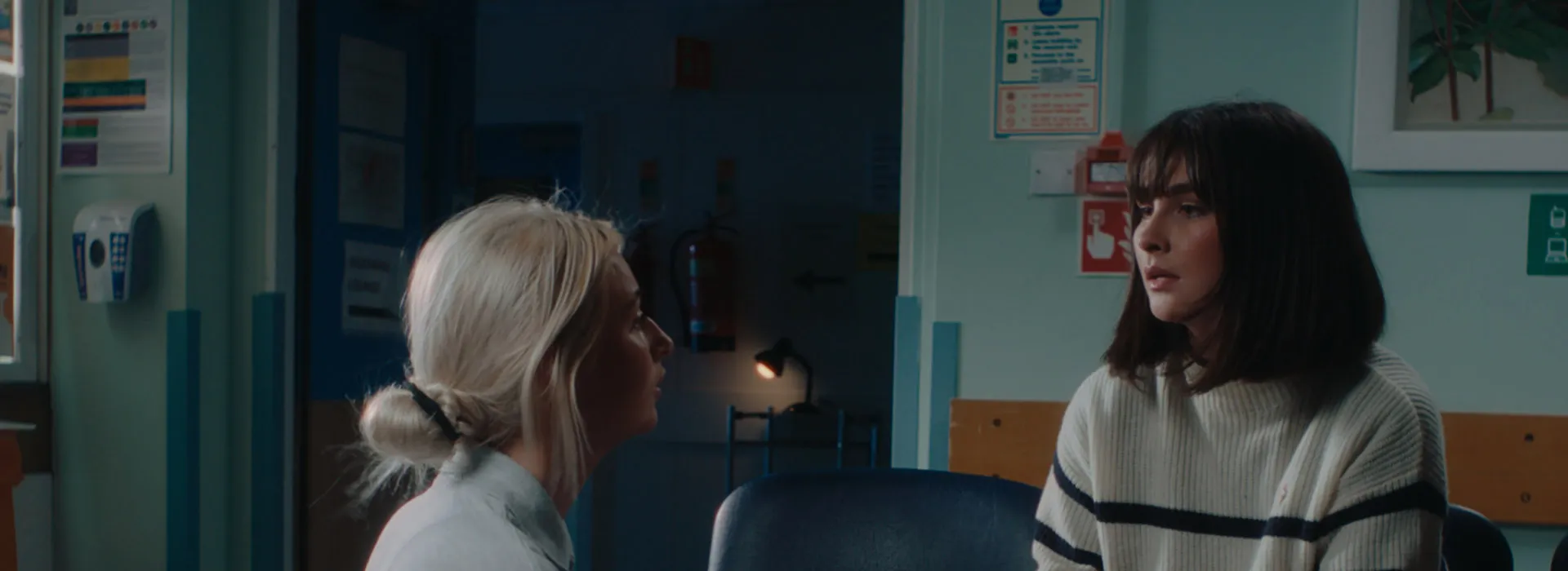 health professional speaking to a patient in a waiting room