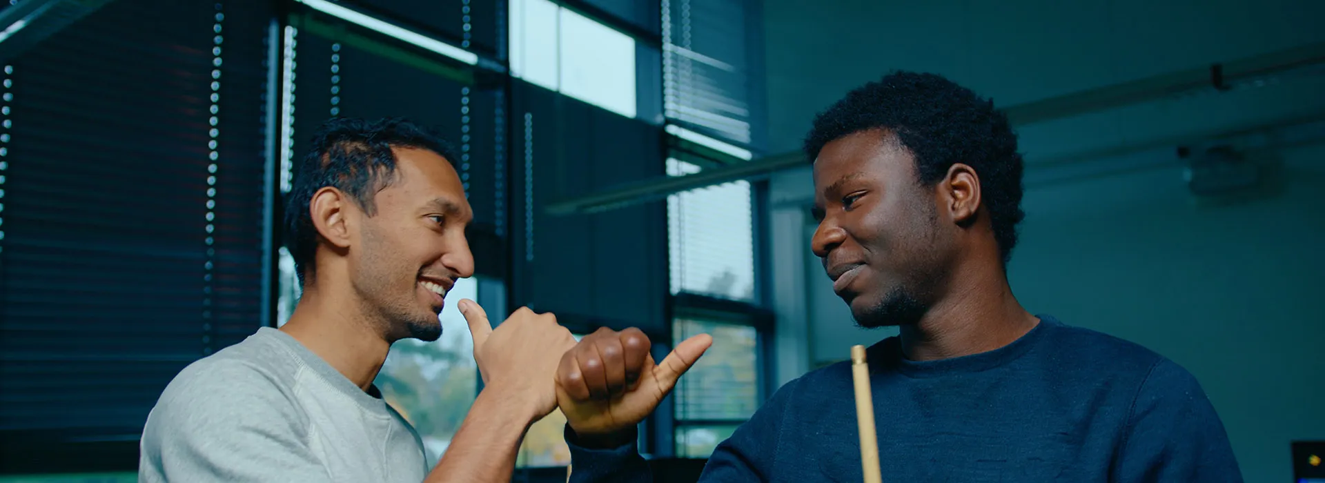 two students playing pool