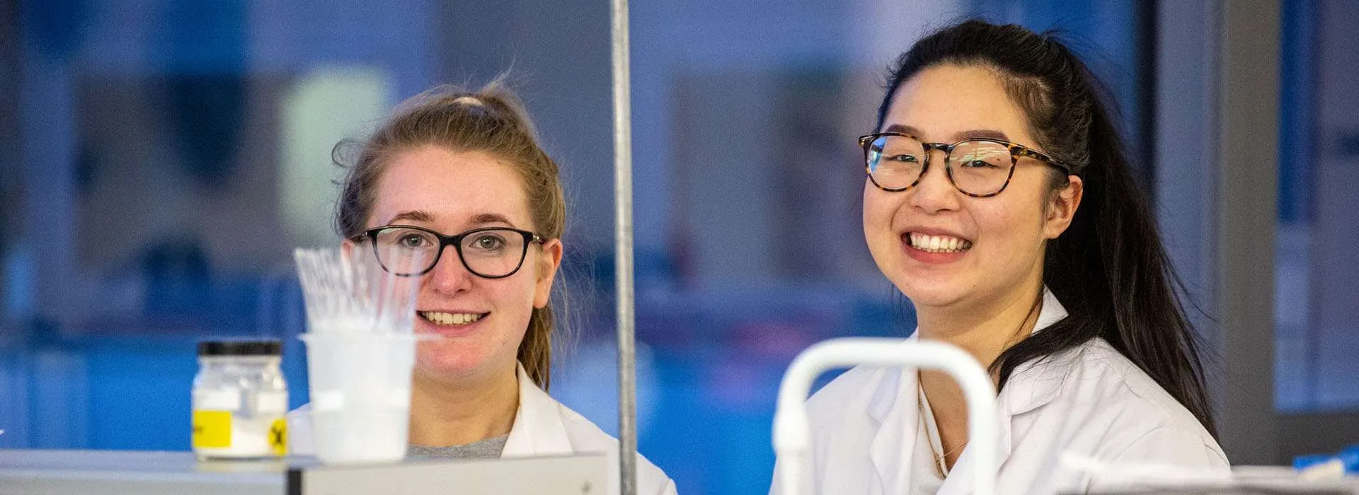 students smiling in a laboratory