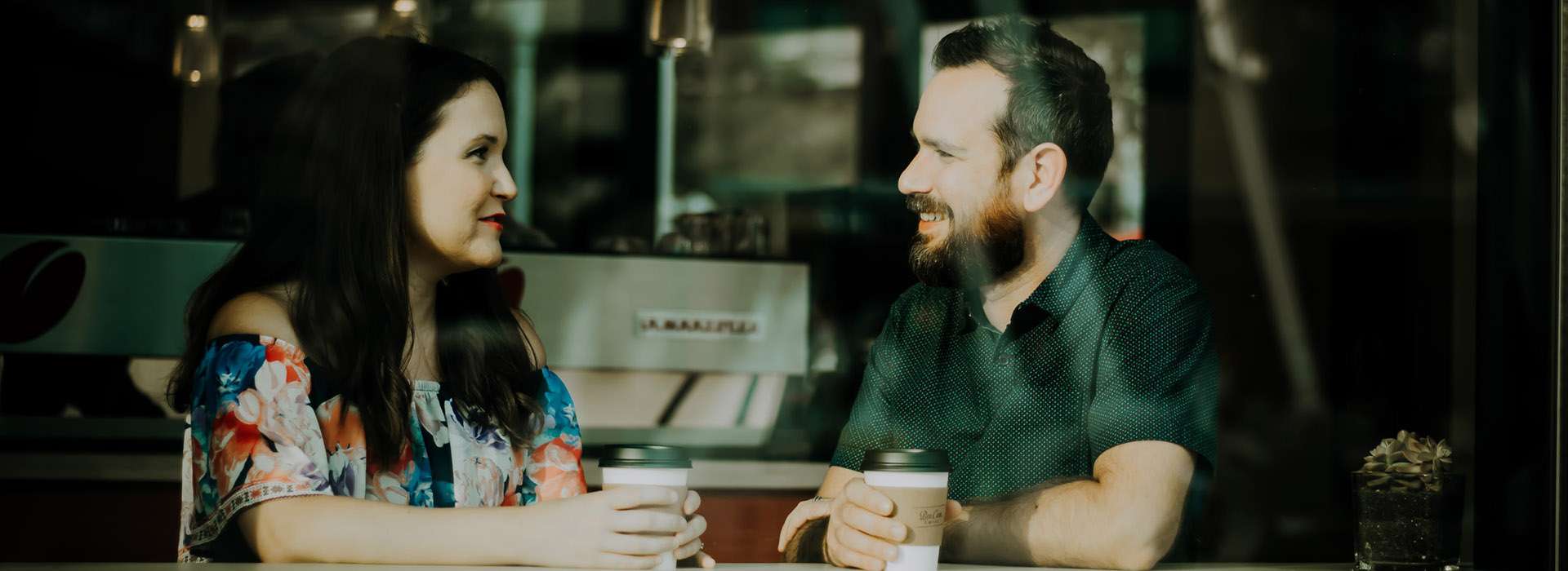 two people having a conversation at a cafe