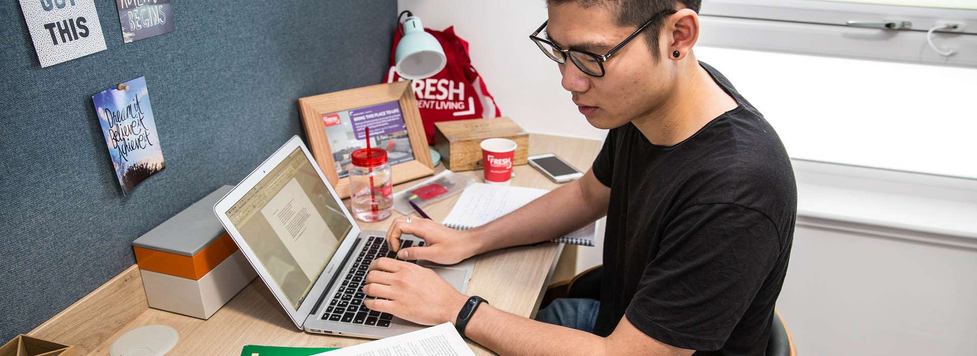 student sitting working at a desk