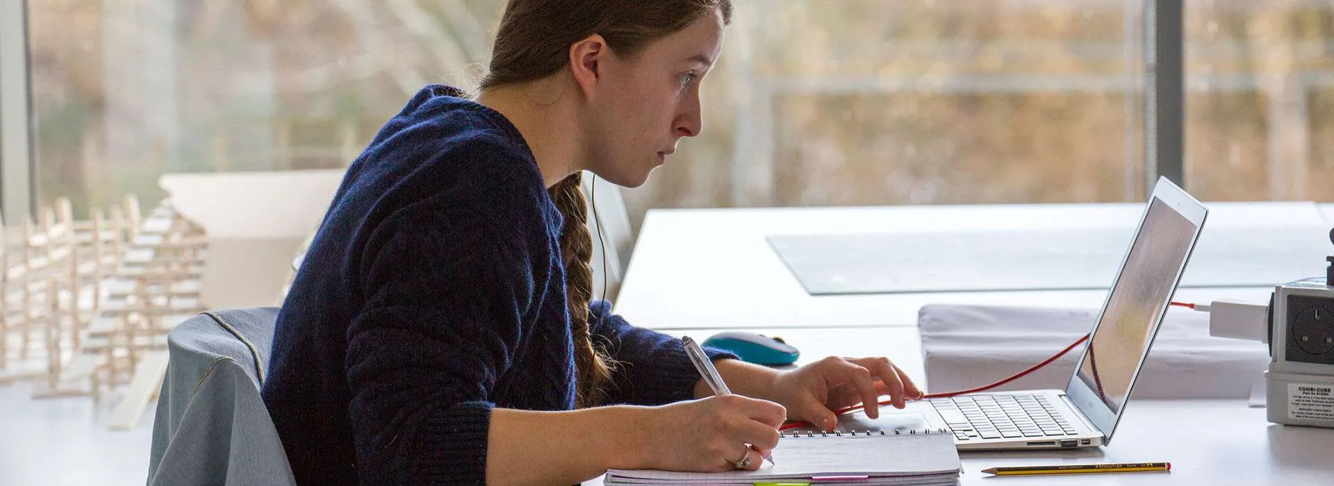 student on laptop in classroom