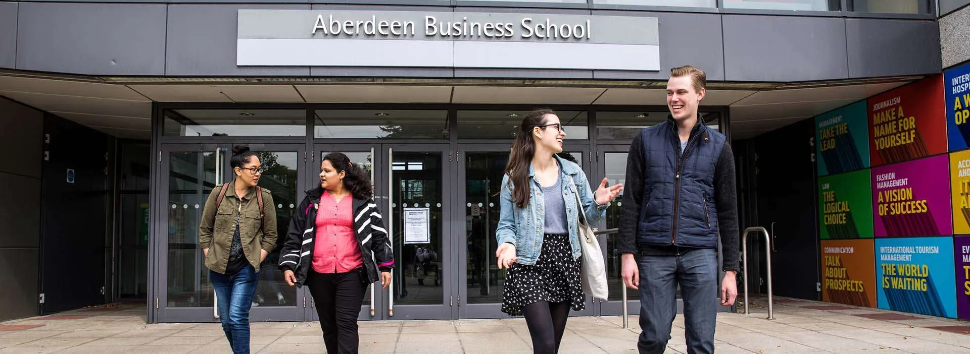 students walking out of university building
