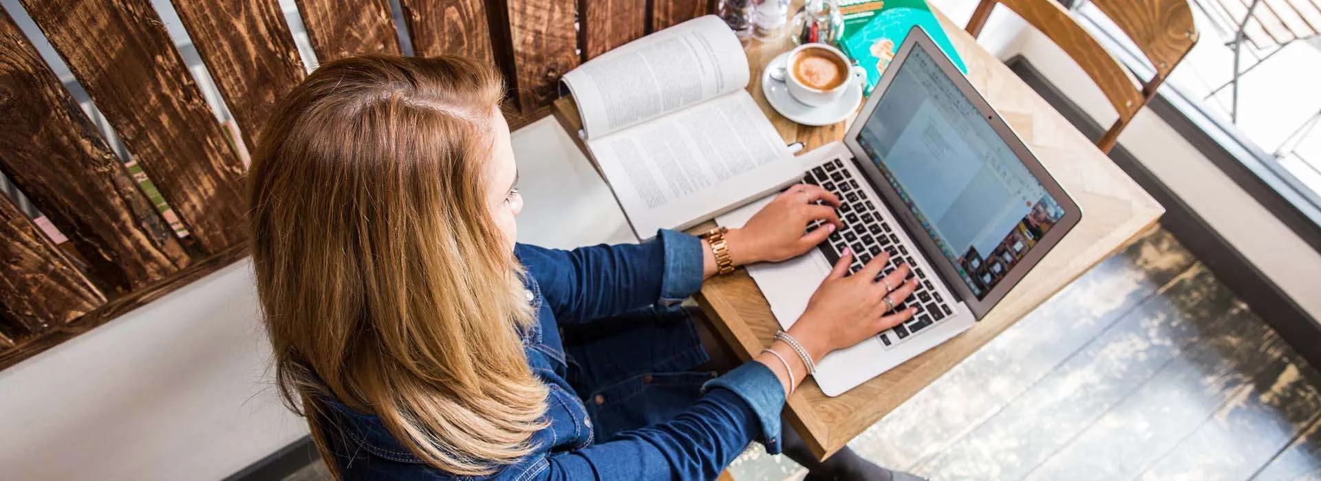 student working on a laptop in a cafe