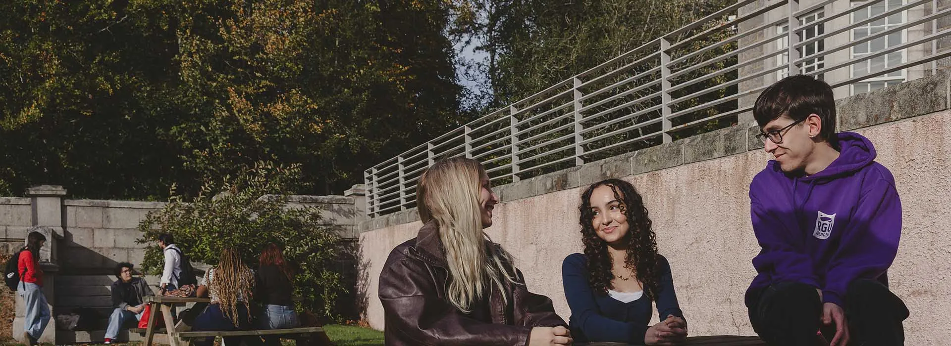 two women smiling at one another in meeting room