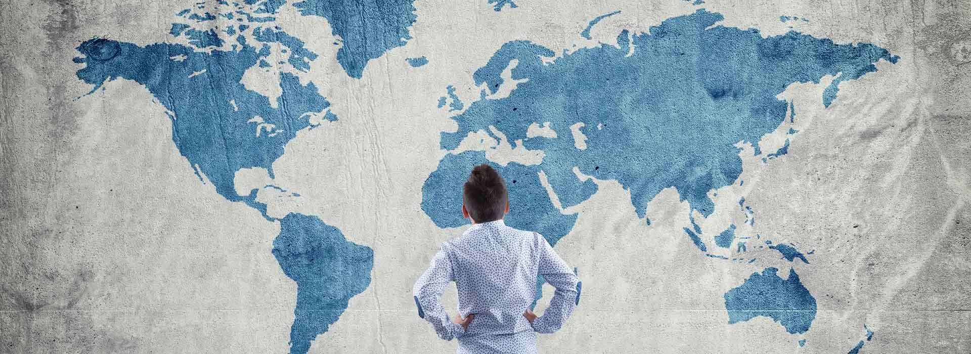 child looking at a world map