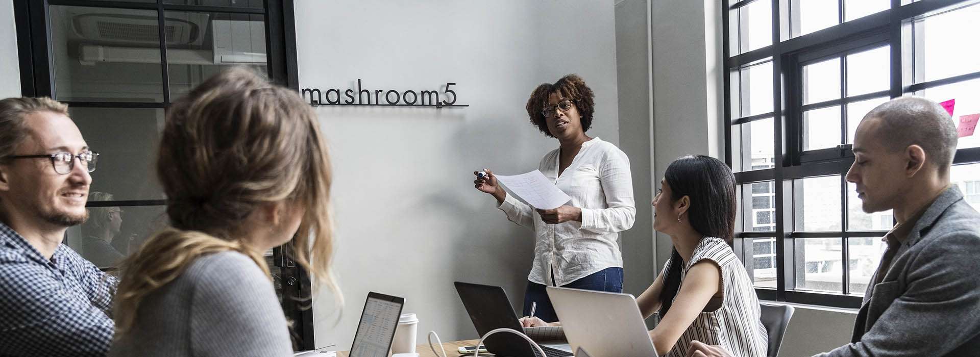 people having a meeting with laptops on the table