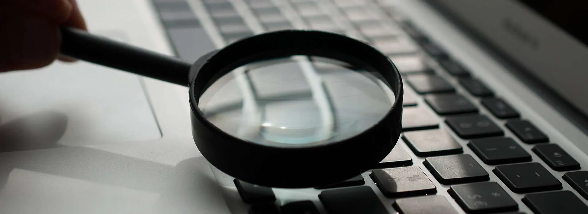magnifying glass on laptop keyboard