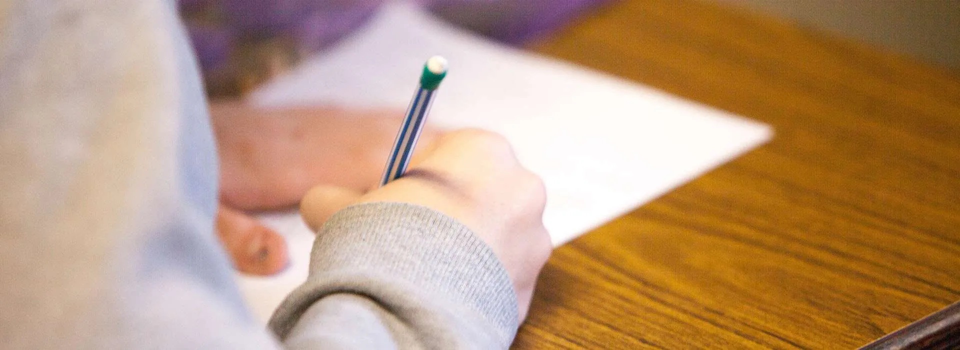 person writing on a piece of paper