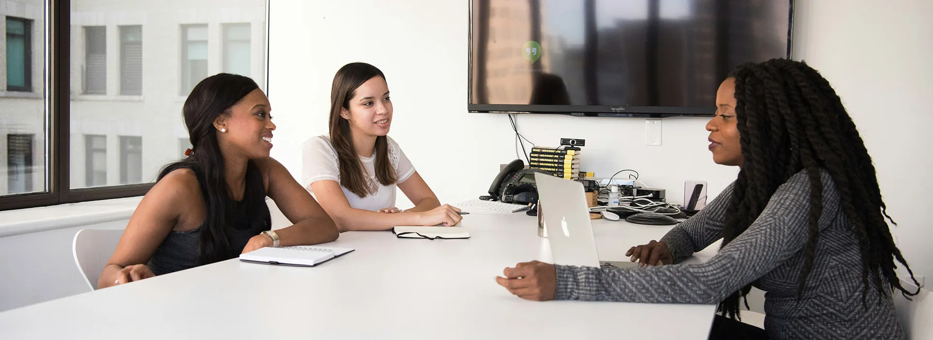 people chatting at a desk