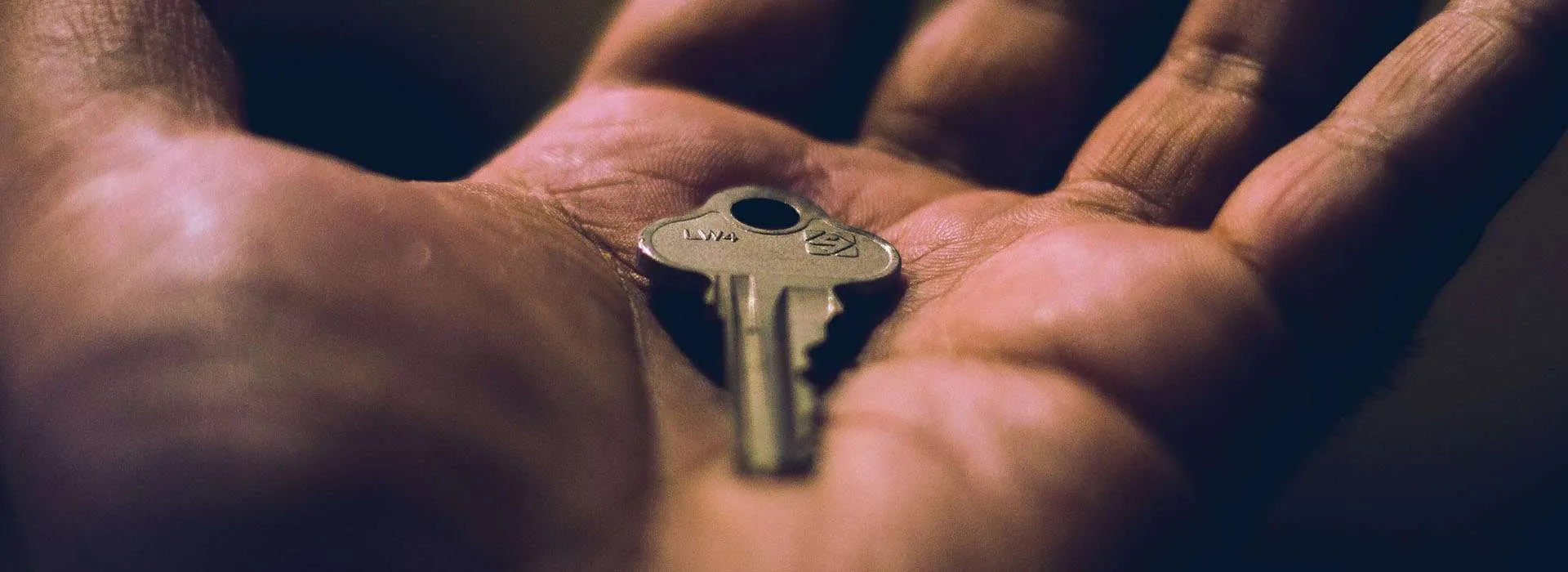 close up of a hand holding a key