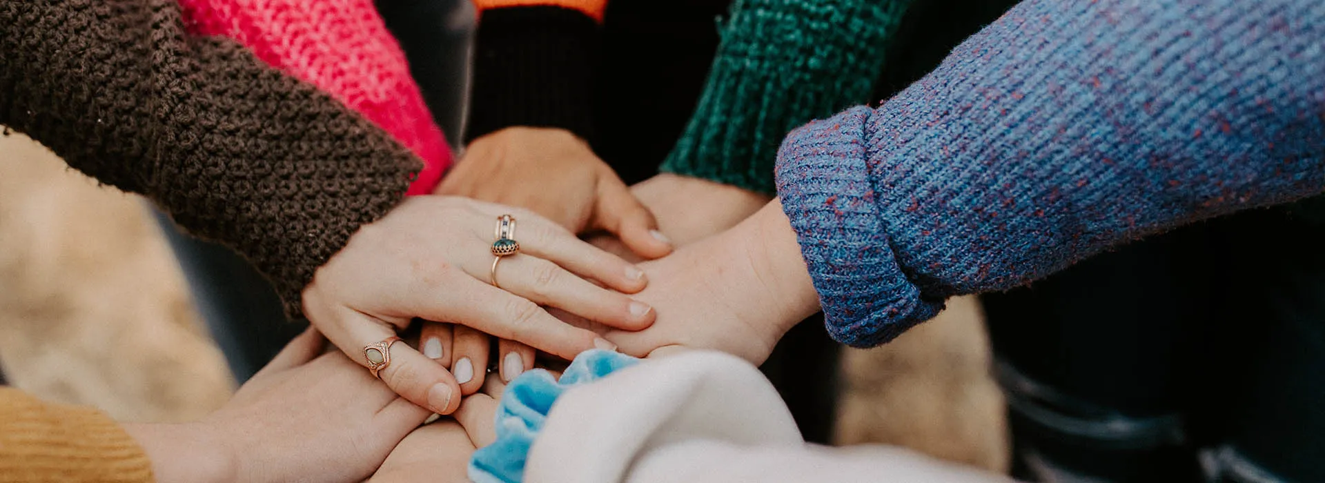 people putting their hands together in the middle