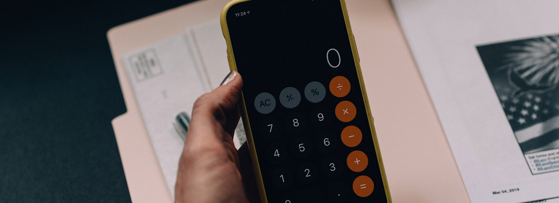 Person holding a phone with a calculator on screen